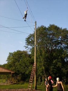Jennifer Croker participates in an event hosted by PAVE at the UI Outdoor Creation Challenge Course. Team leader Tiffany Baker-Strothkamp says the event focused on the important of building a support network and trusting those you choose to be involved in your life.