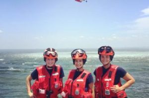 Student veteran and two other women standing together during a training