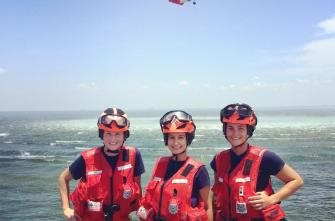 Student veteran and two other women standing together during a training