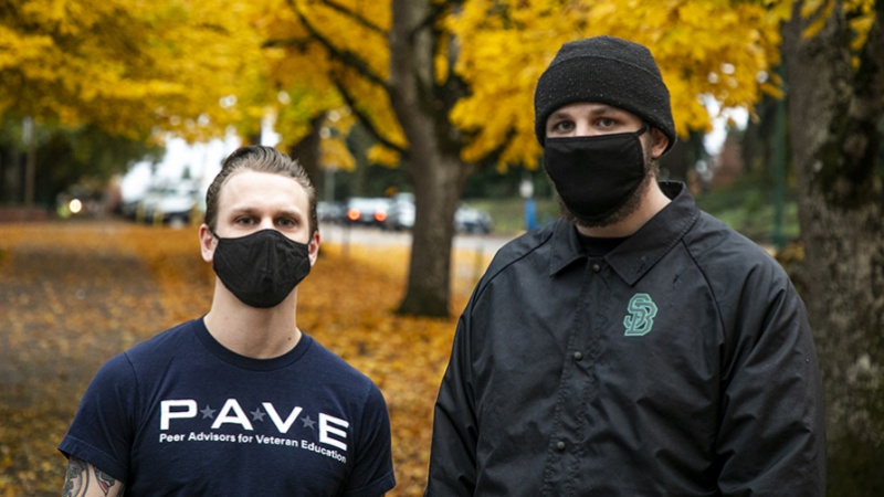 Two student veterans standing together with their masks on