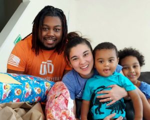 Student veteran Jeff Wilson smiling for a picture with his wife and two children