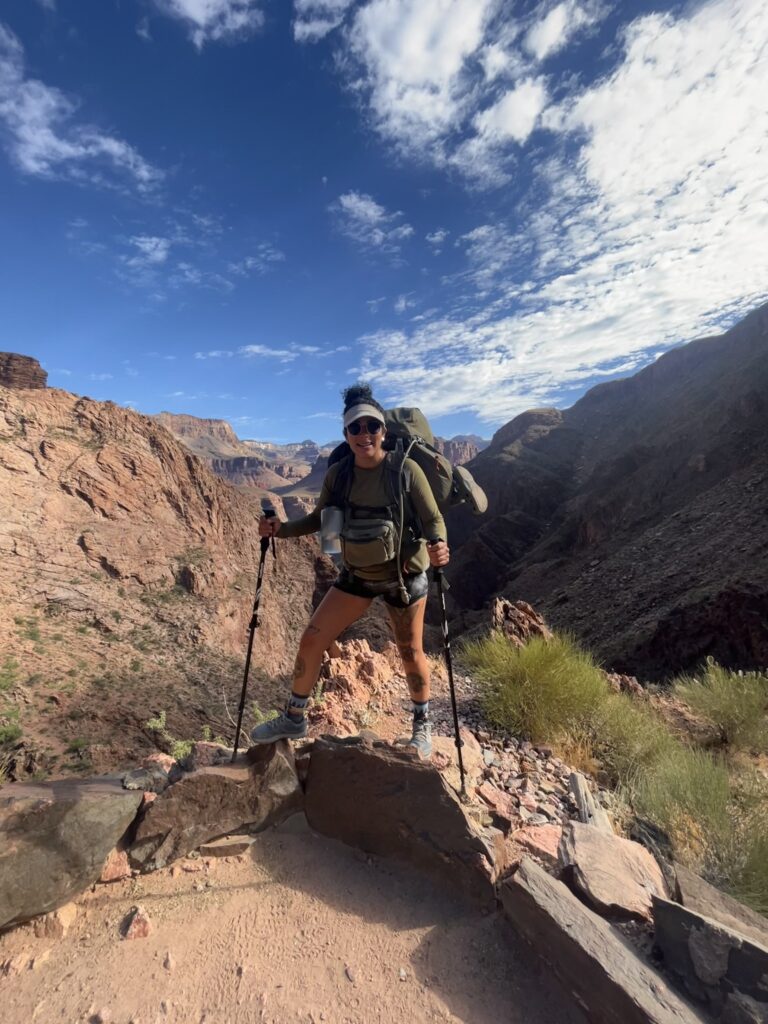 Person in hiking gear standing in a mountainside
