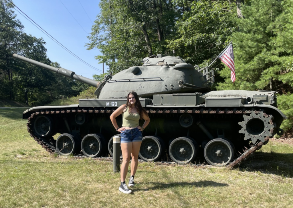 PA standing in front of a military tank